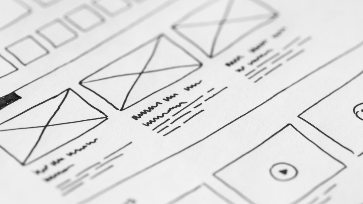 Detailed close-up of a hand-drawn wireframe design on paper for a UX project.